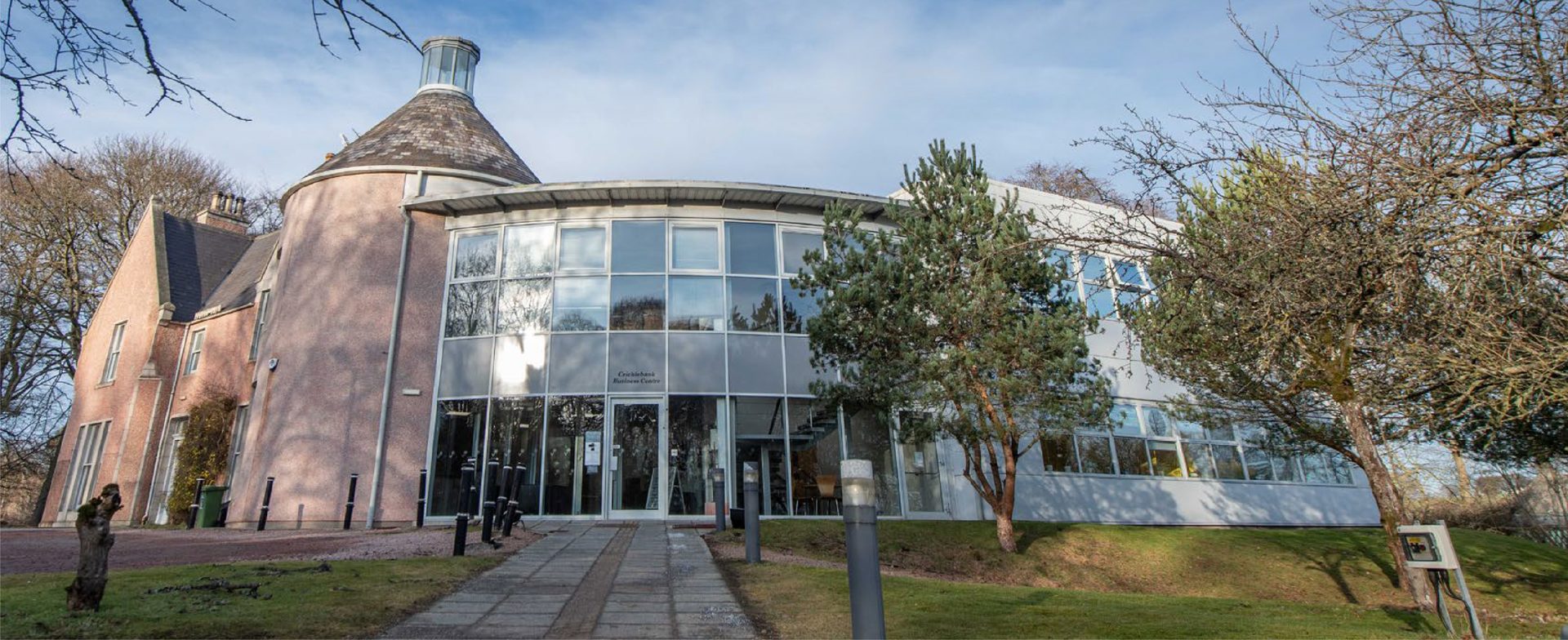 Havenbank commercial property featuring a distinctive round-fronted glass building surrounded by mature trees